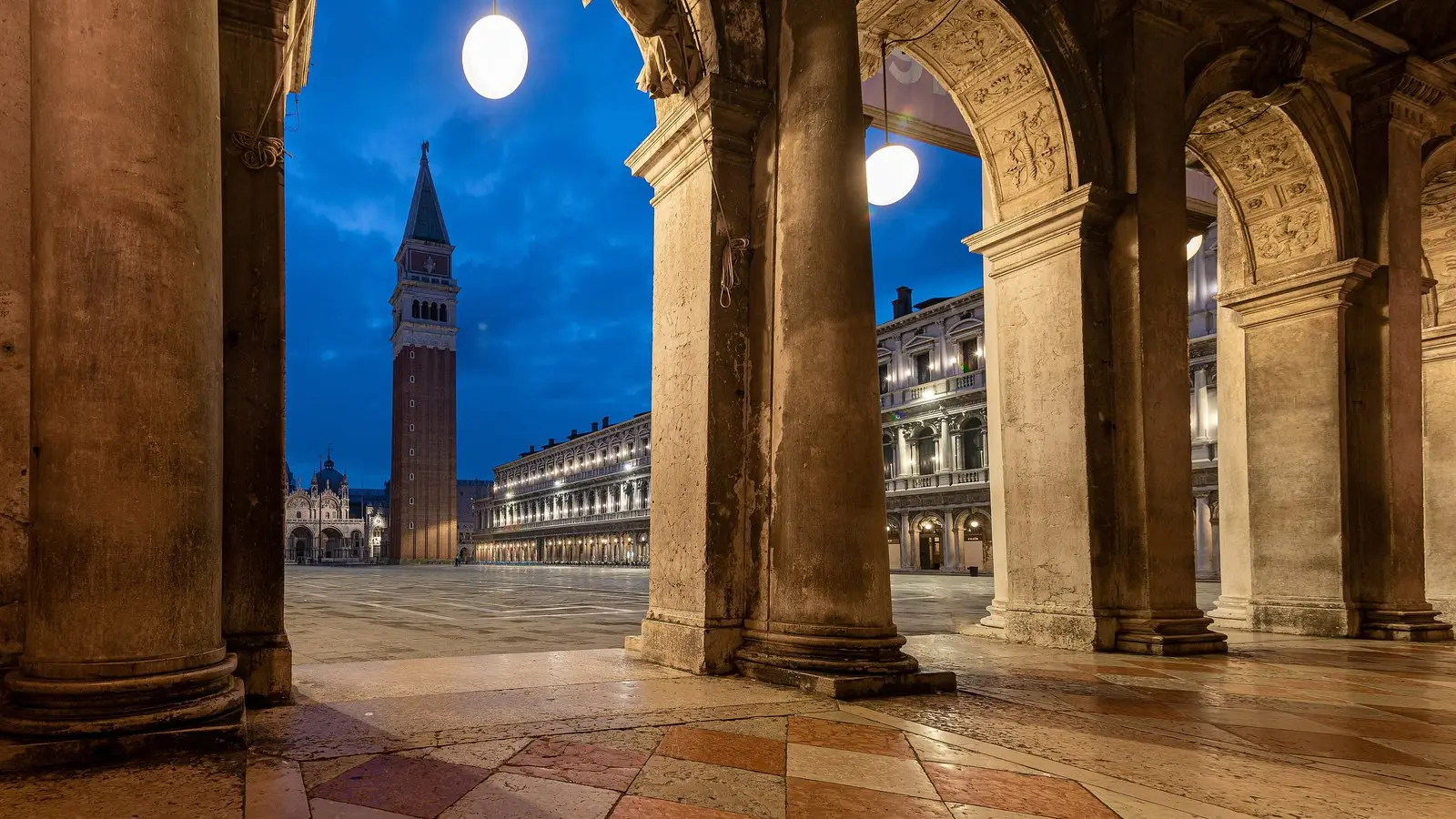 St. Mark's Basilica glowing with Byzantine golden mosaics and arcades in morning light at Piazza San Marco.